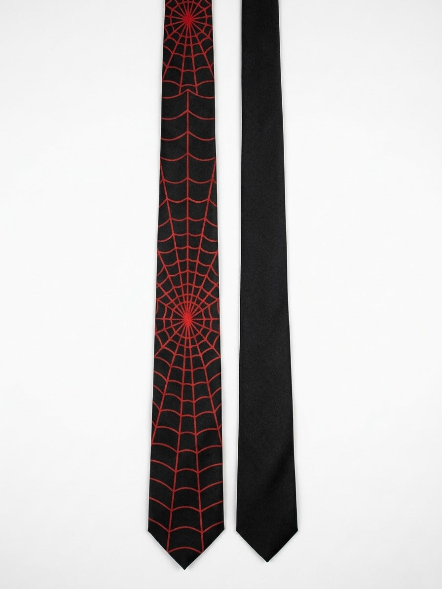 Two black neckties displayed side by side on a plain white background. The tie on the left features a red spiderweb pattern, while the tie on the right is solid black.