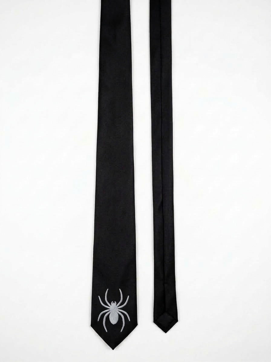 A black necktie with a white spider graphic printed on the tip, displayed next to its matching black ribbon end on a plain white background.