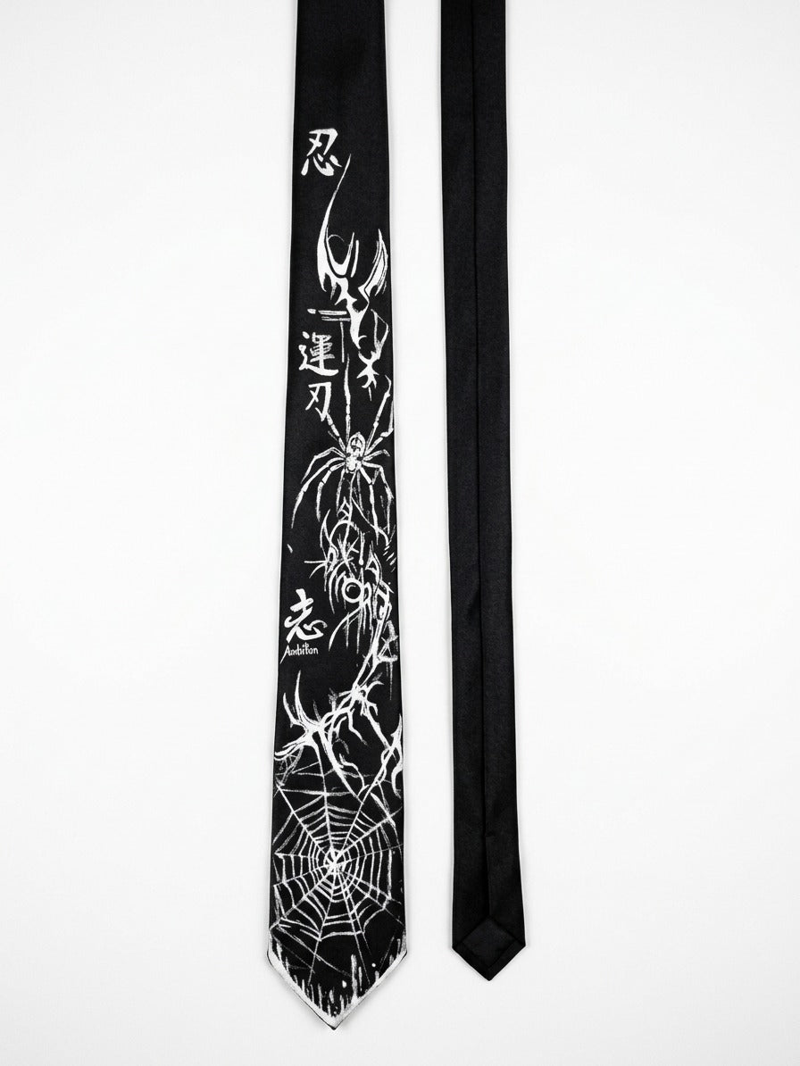 A black necktie with a white spider-themed graphic print featuring a large spider, web patterns, and Japanese characters, displayed next to a plain black necktie on a white background.