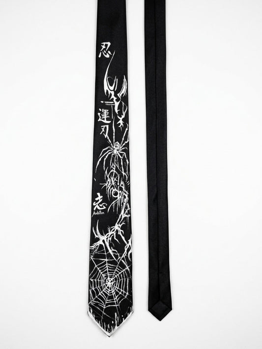 A black necktie with a white spider-themed graphic print featuring a large spider, web patterns, and Japanese characters, displayed next to a plain black necktie on a white background.